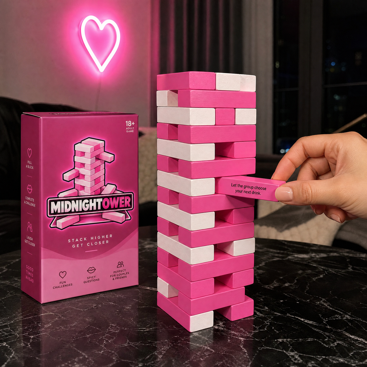 A hand pulling a pink dare block from the Midnightower tower